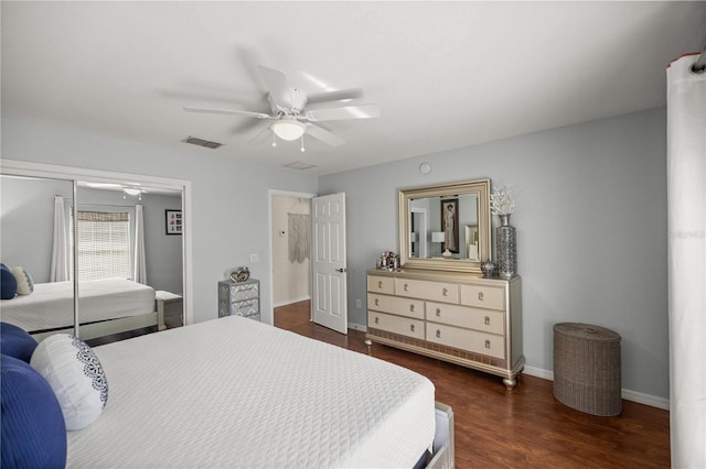 bedroom with dark wood-type flooring, ceiling fan, and a closet