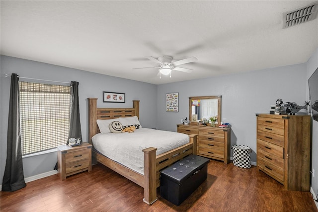 bedroom with multiple windows, dark hardwood / wood-style floors, and ceiling fan