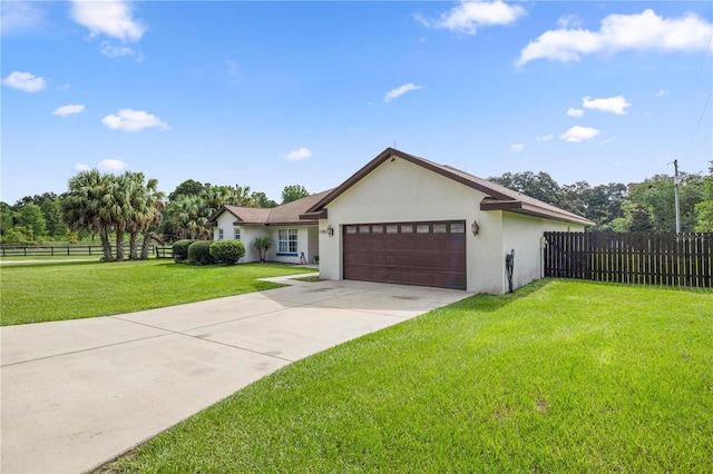 view of front of house featuring a garage and a front yard