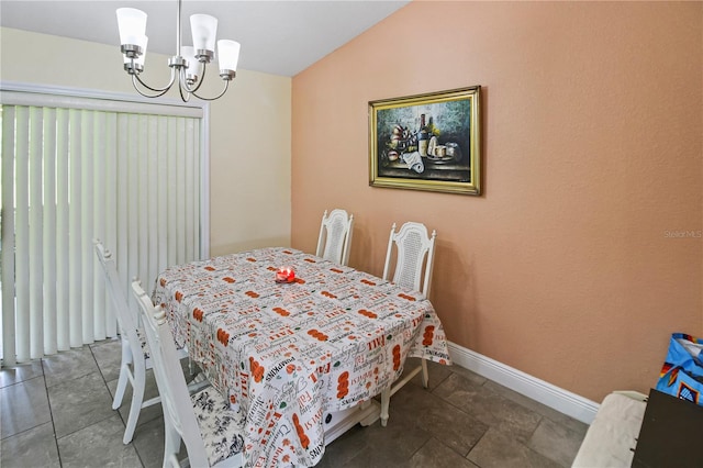 dining area featuring an inviting chandelier and vaulted ceiling