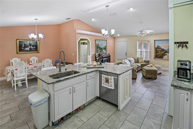 kitchen with ceiling fan with notable chandelier, pendant lighting, sink, lofted ceiling, and white cabinets