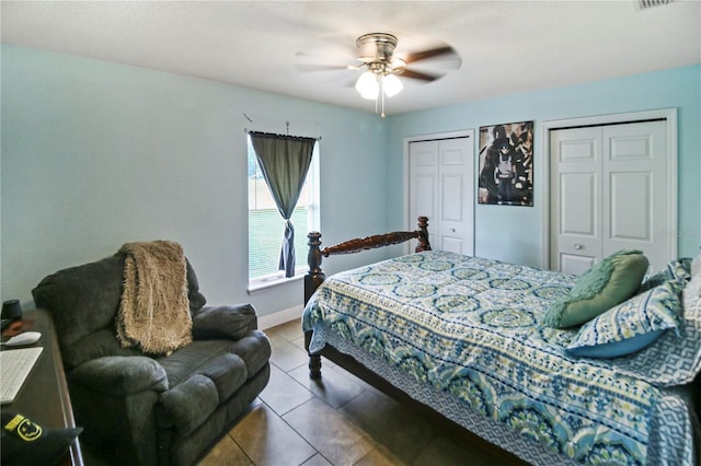 bedroom with multiple closets, ceiling fan, and tile patterned flooring