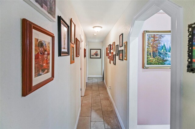 hall with light tile patterned floors