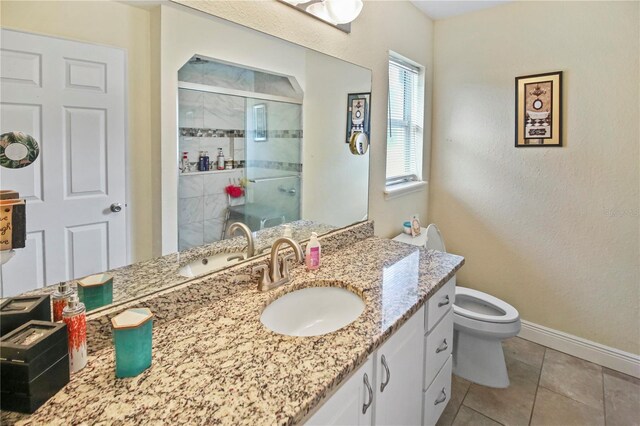 bathroom with tile patterned flooring, toilet, a shower with door, and vanity