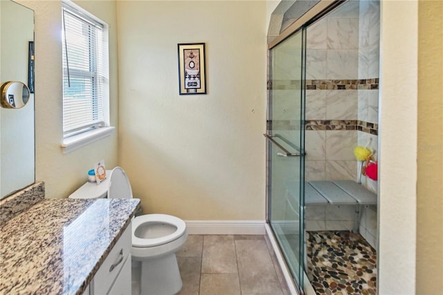 bathroom featuring vanity, toilet, tile patterned floors, and a shower with door