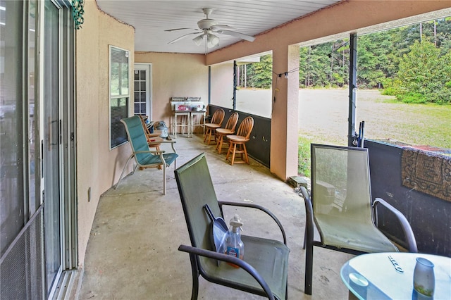 sunroom / solarium featuring ceiling fan