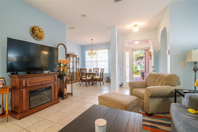 living room featuring light tile patterned flooring and a notable chandelier