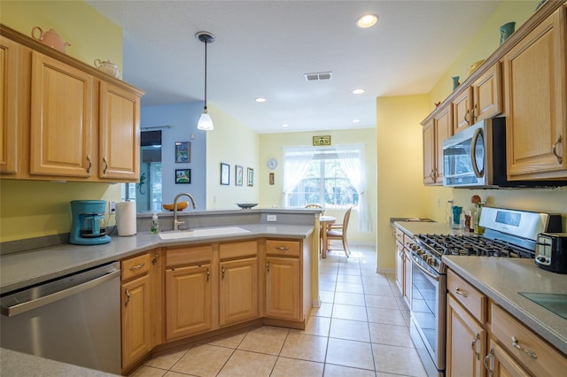 kitchen with sink, hanging light fixtures, stainless steel appliances, light tile patterned flooring, and kitchen peninsula