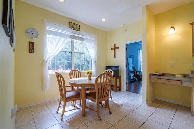 dining area featuring light tile patterned flooring