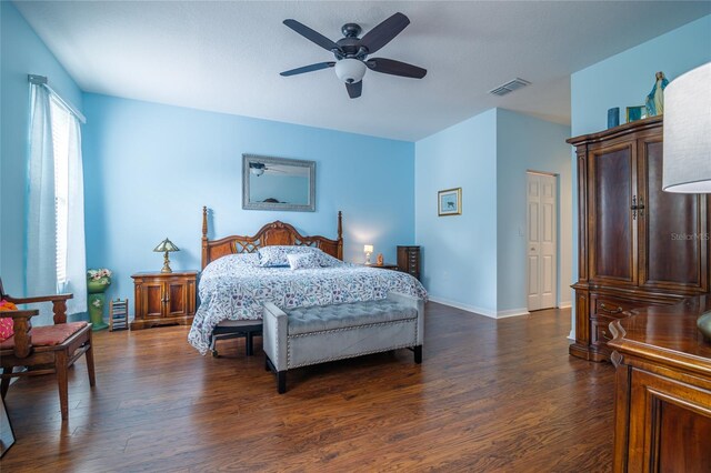 bedroom with dark hardwood / wood-style floors and ceiling fan