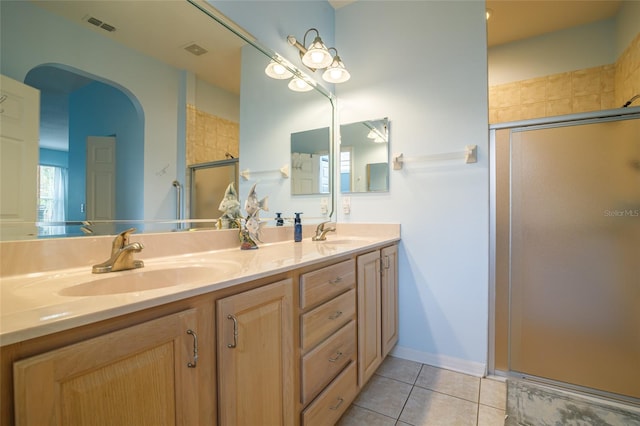 bathroom featuring tile patterned flooring and double sink vanity