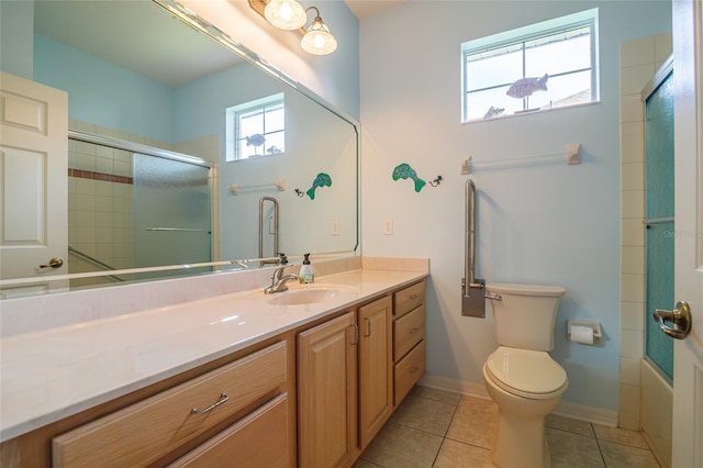 full bathroom with vanity, bath / shower combo with glass door, tile patterned floors, and toilet