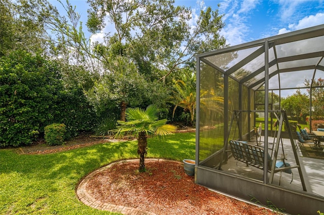 view of yard with a patio area and glass enclosure