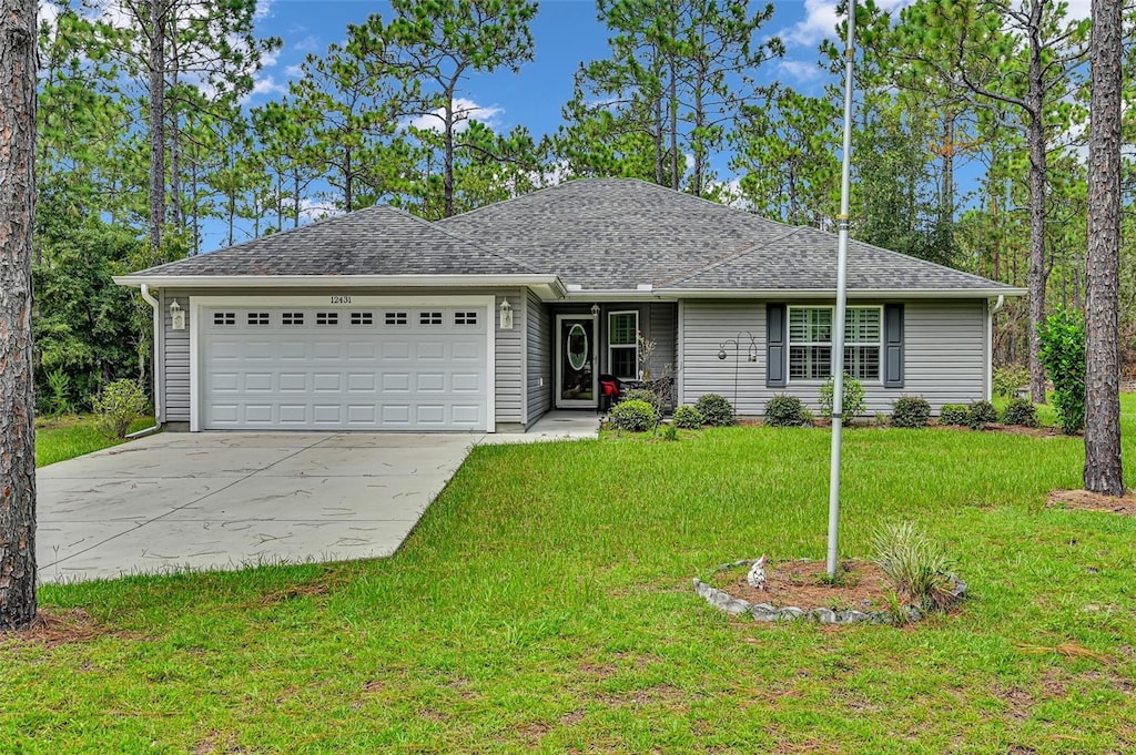 ranch-style home featuring a garage and a front yard