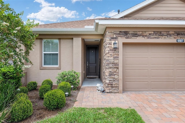 view of exterior entry with a garage