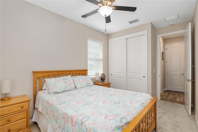 bedroom with light colored carpet, a closet, and ceiling fan