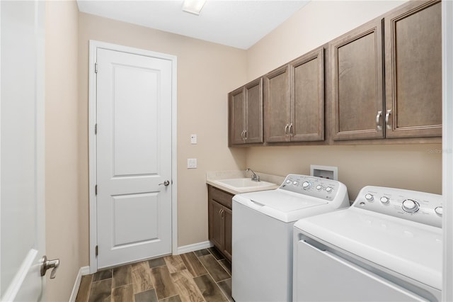 laundry area featuring cabinets, sink, and washing machine and clothes dryer