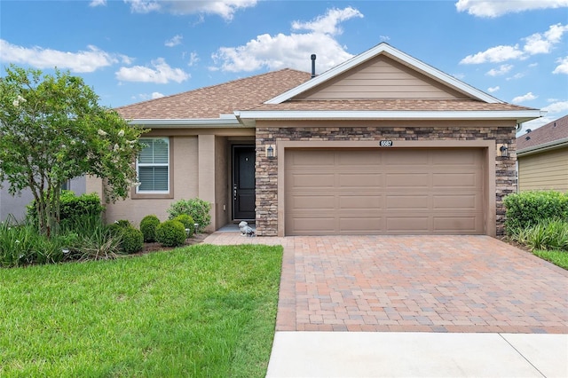 ranch-style home with a garage and a front lawn