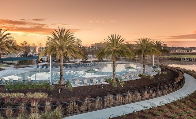 view of pool at dusk