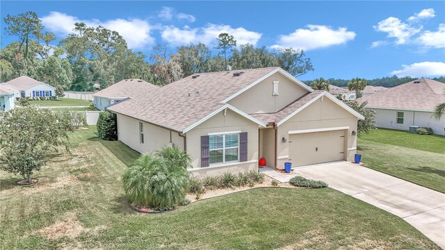 single story home featuring a garage and a front lawn