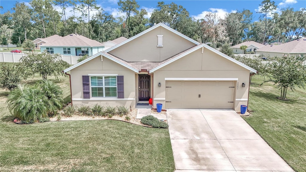 view of front of property featuring a garage and a front lawn