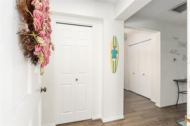 foyer with wood-type flooring and a textured ceiling