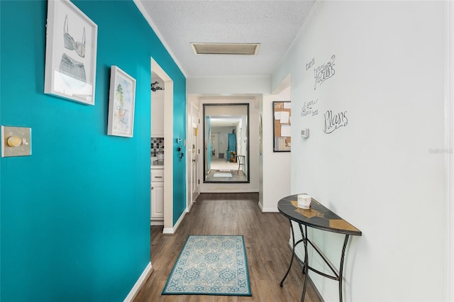 hallway with dark hardwood / wood-style floors and a textured ceiling