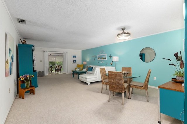 carpeted dining space featuring a textured ceiling