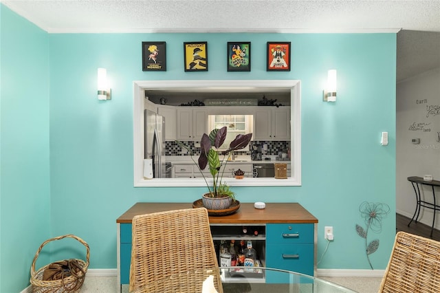 interior space featuring crown molding and a textured ceiling