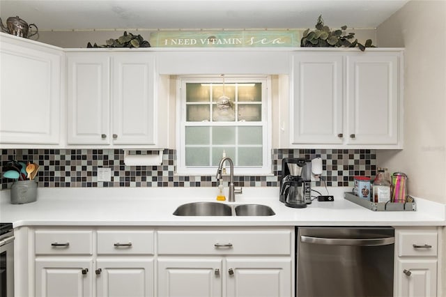 kitchen with tasteful backsplash, dishwasher, sink, and white cabinets