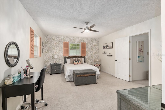 carpeted bedroom featuring a textured ceiling and ceiling fan