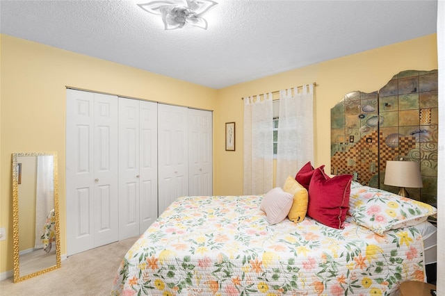 bedroom featuring a closet, light carpet, and a textured ceiling