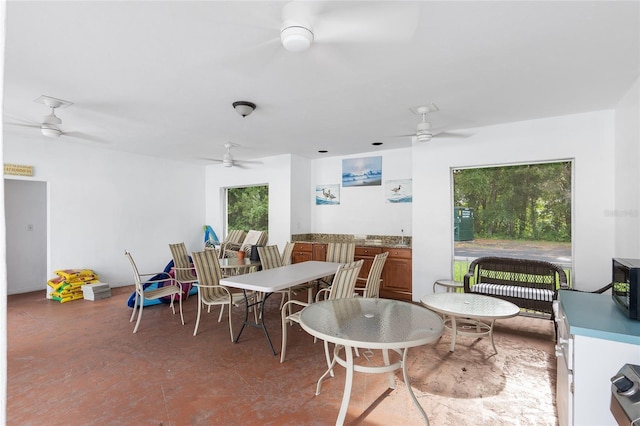 dining room featuring ceiling fan and a healthy amount of sunlight