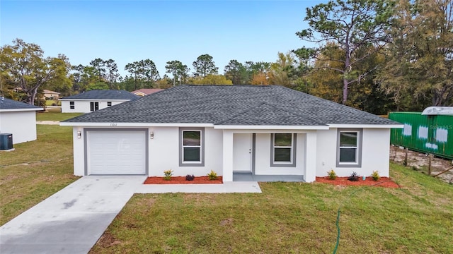 single story home with a garage, a front yard, and cooling unit