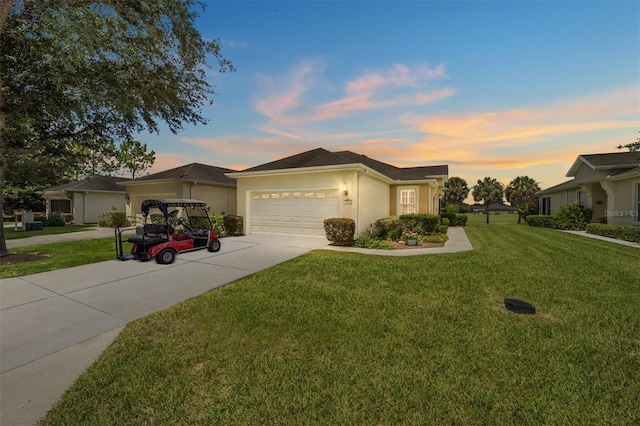 single story home with a garage and a lawn