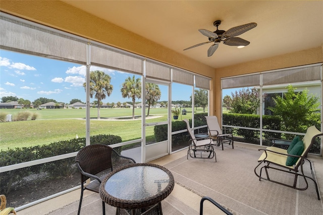 sunroom / solarium featuring ceiling fan