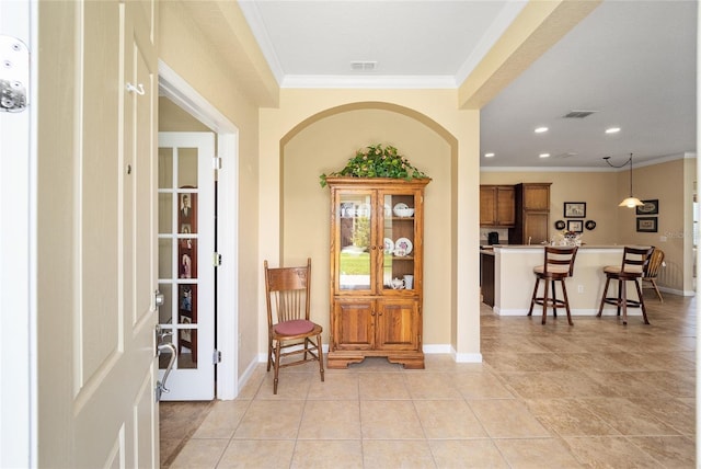 tiled entrance foyer with crown molding