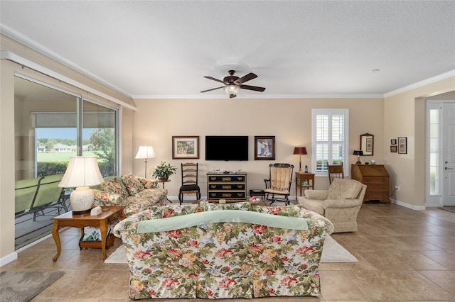 living room featuring ceiling fan, a textured ceiling, light tile patterned floors, and ornamental molding