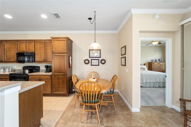 kitchen featuring black appliances, ceiling fan, decorative light fixtures, crown molding, and light colored carpet