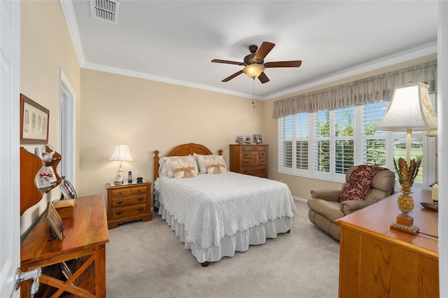 carpeted bedroom featuring ceiling fan and crown molding