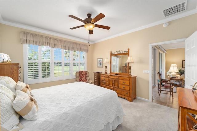 bedroom featuring ornamental molding, light carpet, and ceiling fan