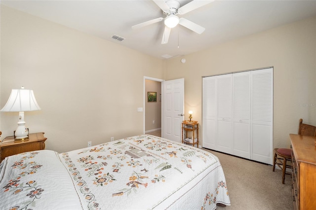 carpeted bedroom with ceiling fan and a closet