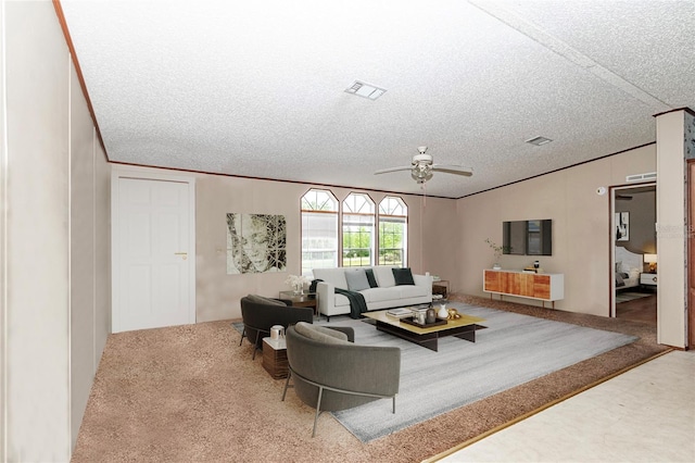 living room featuring visible vents, crown molding, a textured ceiling, and carpet flooring