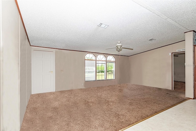 unfurnished room with a textured ceiling, ornamental molding, ceiling fan, and carpet flooring