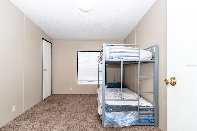 bedroom with carpet and a textured ceiling