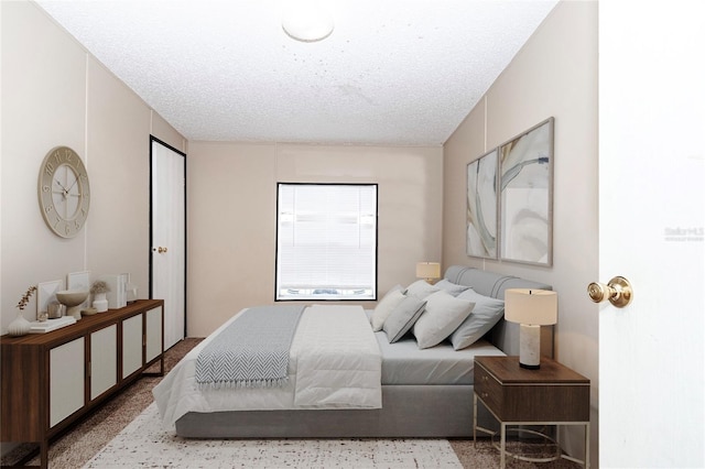 bedroom featuring a textured ceiling and speckled floor