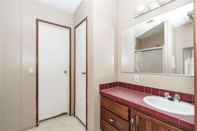 bathroom with vanity and walk in shower