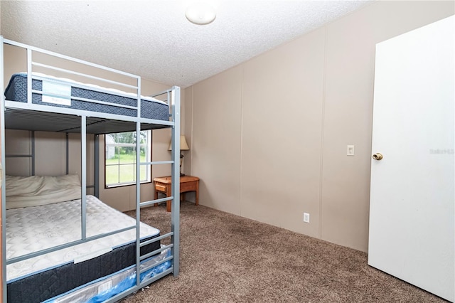 bedroom featuring carpet and a textured ceiling