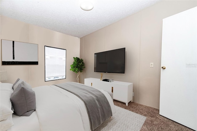 bedroom with light colored carpet and a textured ceiling