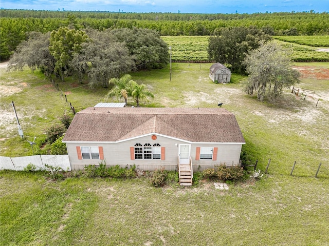 birds eye view of property featuring a rural view and a view of trees